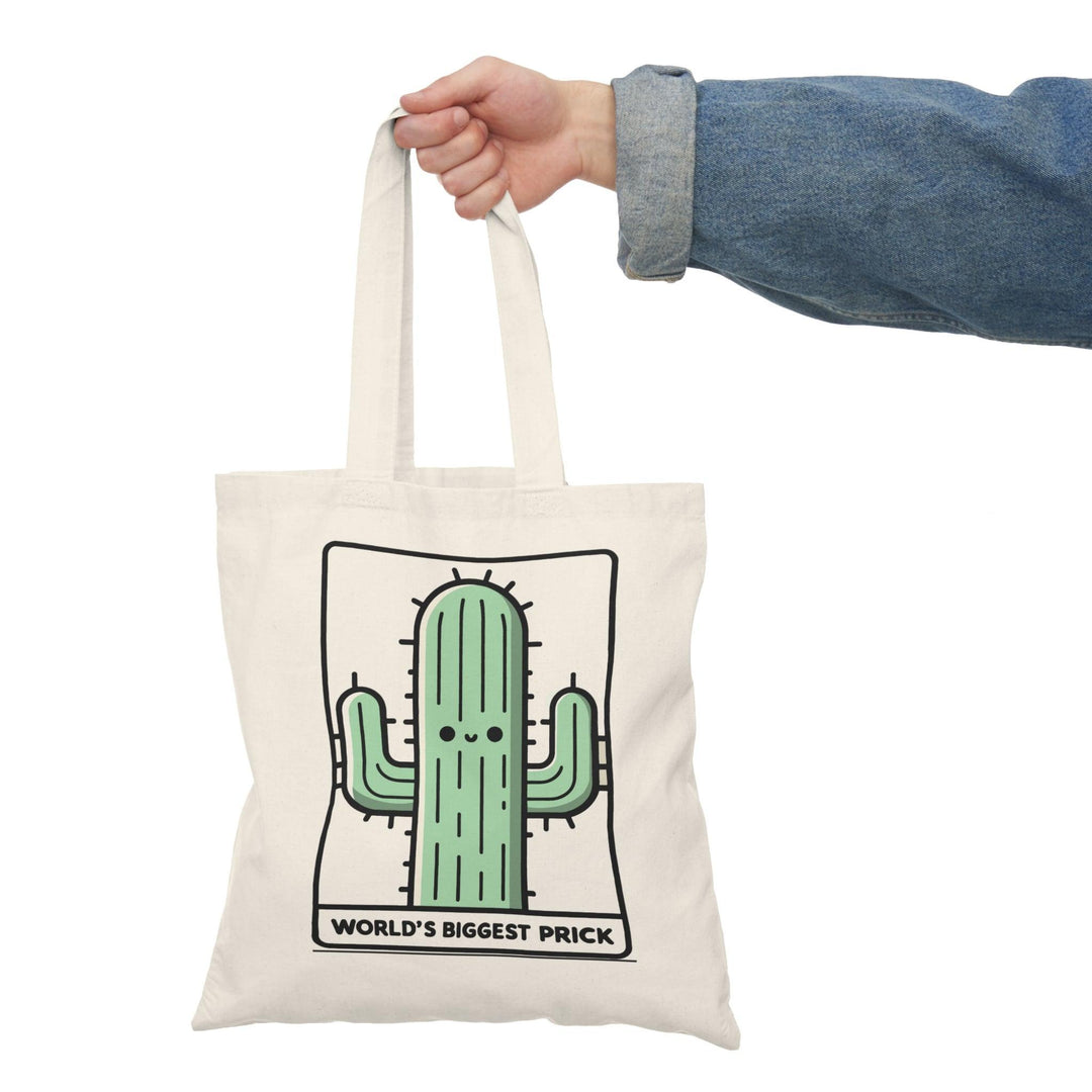 A cream-colored tote bag featuring a humorous graphic of a cartoon cactus with the text 'World's Biggest Prick.' This playful design combines fun and cheeky humor, making it an excellent accessory for those who enjoy a bit of edge in their style. The bag is practical for daily use while showcasing a light-hearted pun.