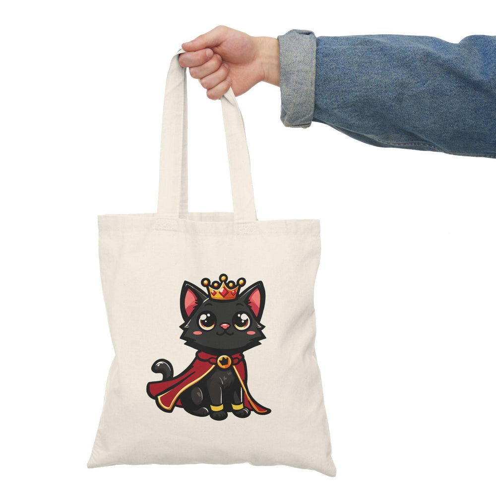tote bag featuring an adorable illustration of a royal kitten wearing a tiny crown, surrounded by playful elements. The charming design and soft colors create a whimsical accessory, perfect for cat lovers and those who enjoy a touch of regal flair in their everyday style.