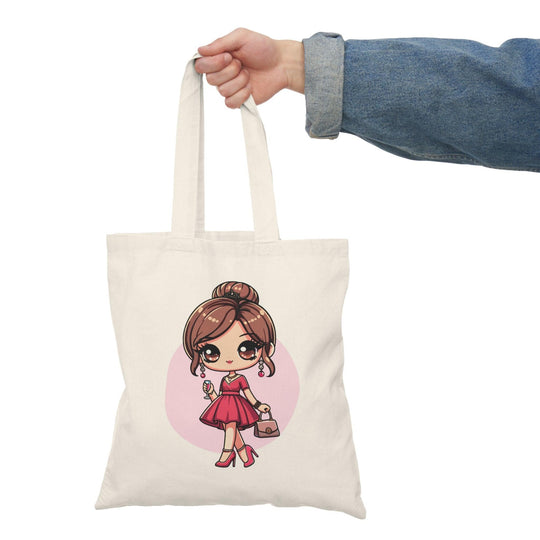A cream tote bag featuring a cute illustration of a young girl dressed as a princess with a crown, in a fun and colorful style. This charming design is perfect for children and those young at heart, adding a playful touch to any outfit.