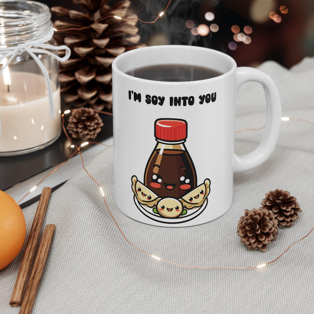 White ceramic mug with a cute sushi and soy sauce illustration and the text 'Soy Into You,' making it a charming gift for foodies or someone special