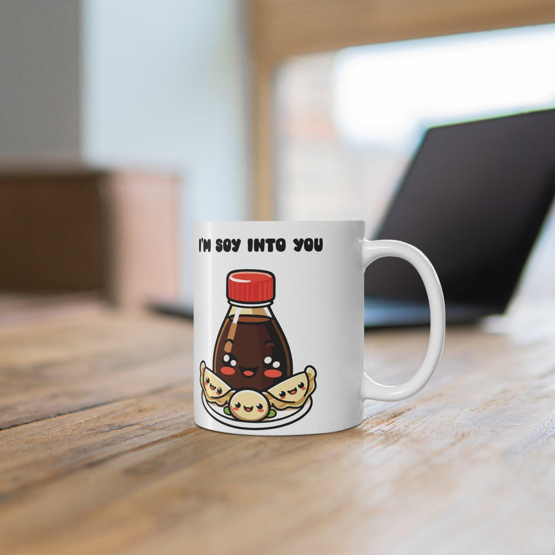 White ceramic mug with a cute sushi and soy sauce illustration and the text 'Soy Into You,' making it a charming gift for foodies or someone special
