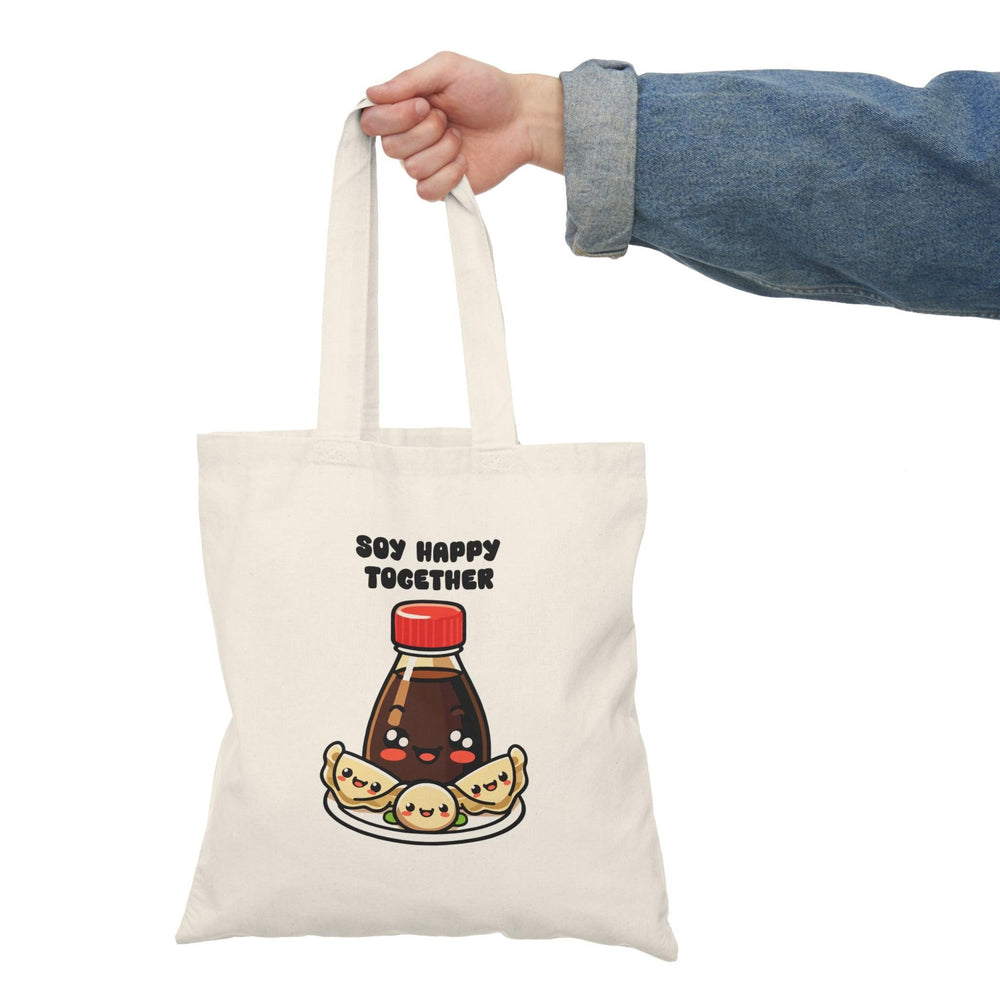 A natural tote bag showcasing a charming graphic of a soy sauce bottle and sushi, with the text 'Soy Better Together.' This punny design appeals to food lovers and adds a delightful touch to dining experiences.
