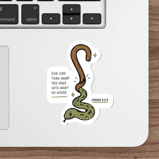 A die-cut sticker featuring a cartoon green and brown snake with the text &