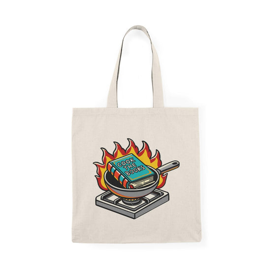 Tote bag featuring a whimsical illustration of a chef's hat resting on an open cookbook, accompanied by playful graphics and the phrase 'Cook the Book.' The vibrant design and fun colors make it an ideal accessory for food lovers and culinary enthusiasts, perfect for carrying groceries or your favorite recipes."