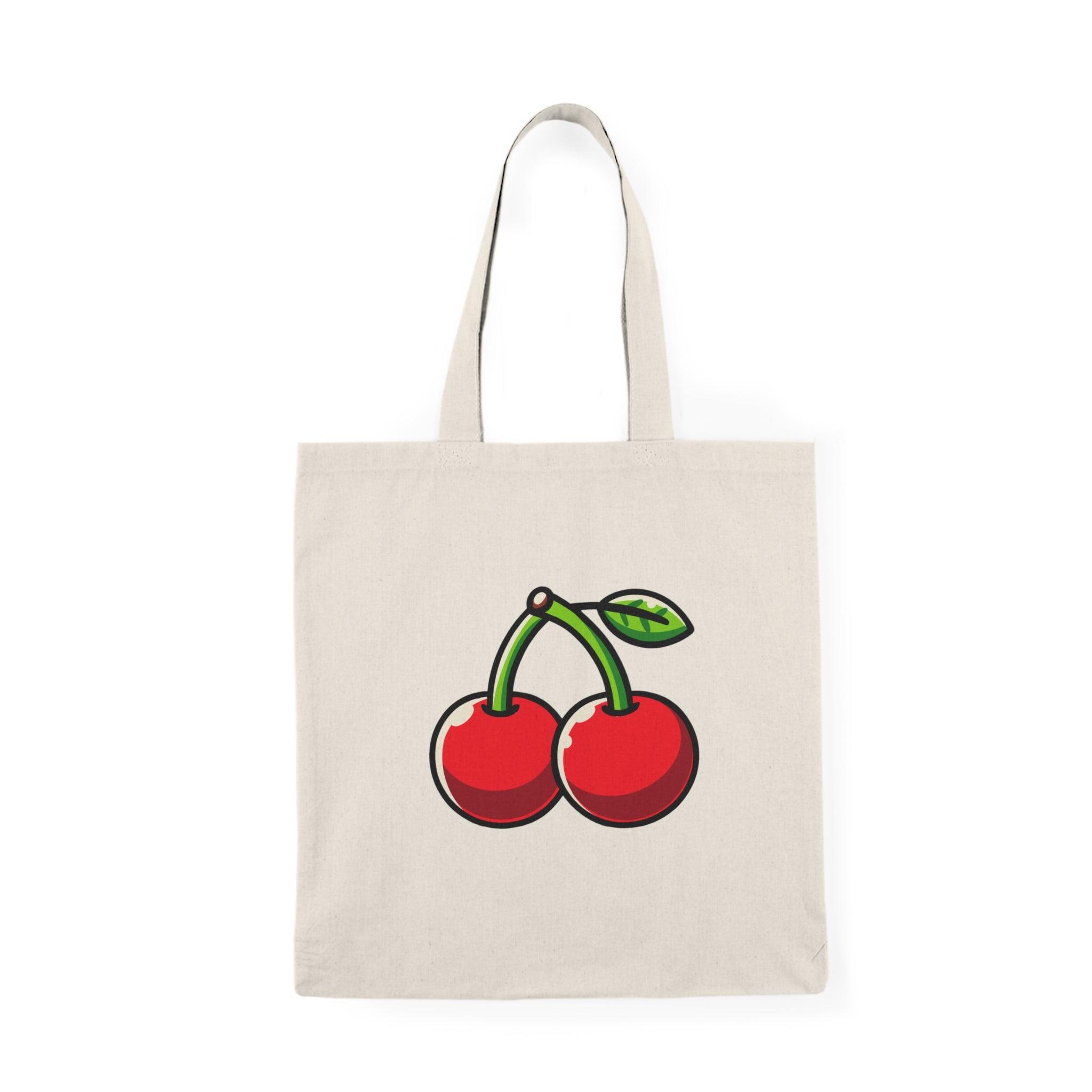 Tote bag featuring a charming design of vibrant red cherries against a soft background. The playful illustration captures the essence of summer and adds a fresh touch to your everyday style, making it a perfect accessory for fruit lovers and anyone seeking a pop of color."