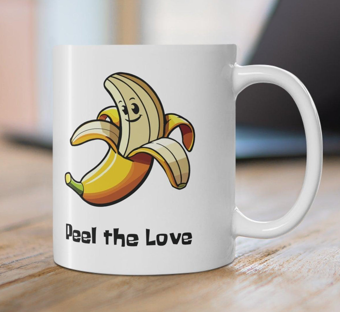 Fun white ceramic mug featuring a smiling cartoon banana and the playful text 'Peel the Love,' ideal for spreading positivity with a cute design KEOLIX 