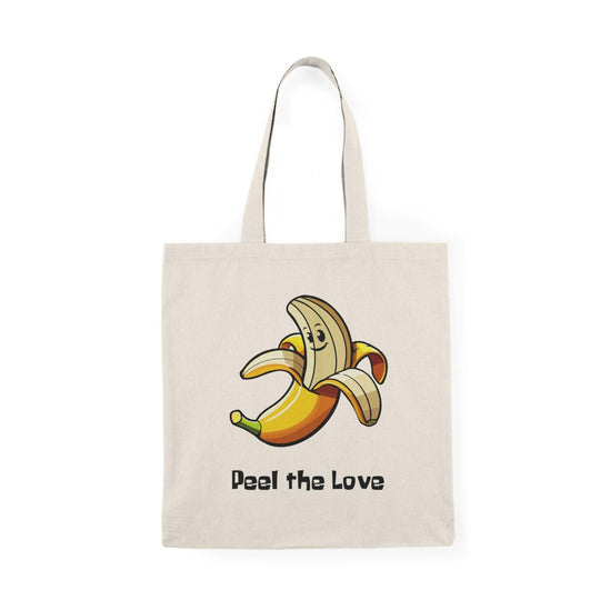 A natural canvas tote bag adorned with a whimsical graphic of a smiling banana character with the phrase 'Peel the Love.' The fun and vibrant design makes this tote a charming choice for fruit lovers and adds a playful element to everyday errands.