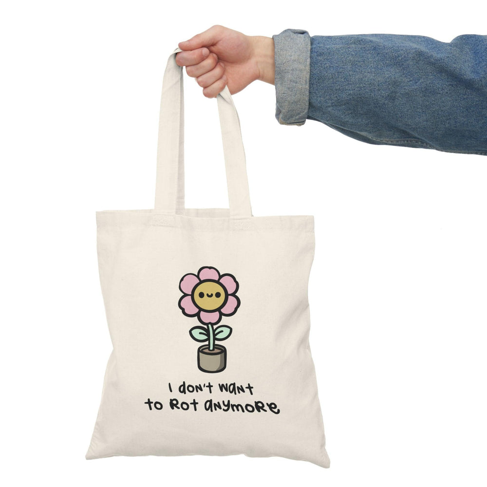Tote bag featuring a humorous and eye-catching design with the phrase 'I Don't Want to Rot Anymore' in bold typography. The playful graphics and vibrant colors add a fun twist, making it a perfect accessory for those who enjoy quirky expressions and want to brighten up their everyday style