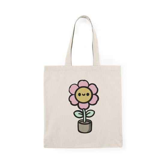 ote bag featuring a cheerful illustration of a cartoon flower blooming in a pot, with vibrant colors and a playful design. This whimsical artwork adds a touch of joy and positivity, making it a perfect accessory for plant lovers and those looking to brighten up their everyday style