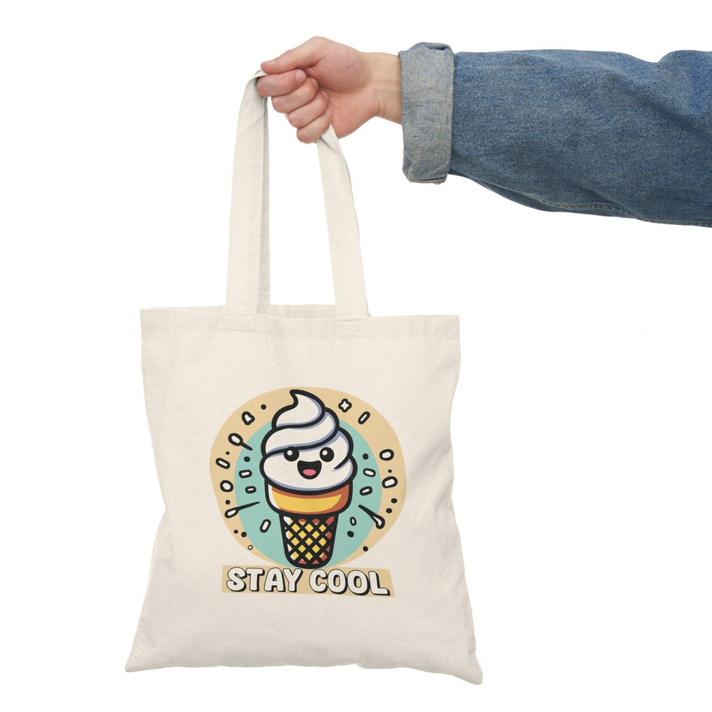A natural canvas tote bag adorned with a fun illustration of a colorful ice cream cone topped with sprinkles and the text 'Stay Cool.' The playful design is perfect for summer outings or anyone with a sweet tooth.
