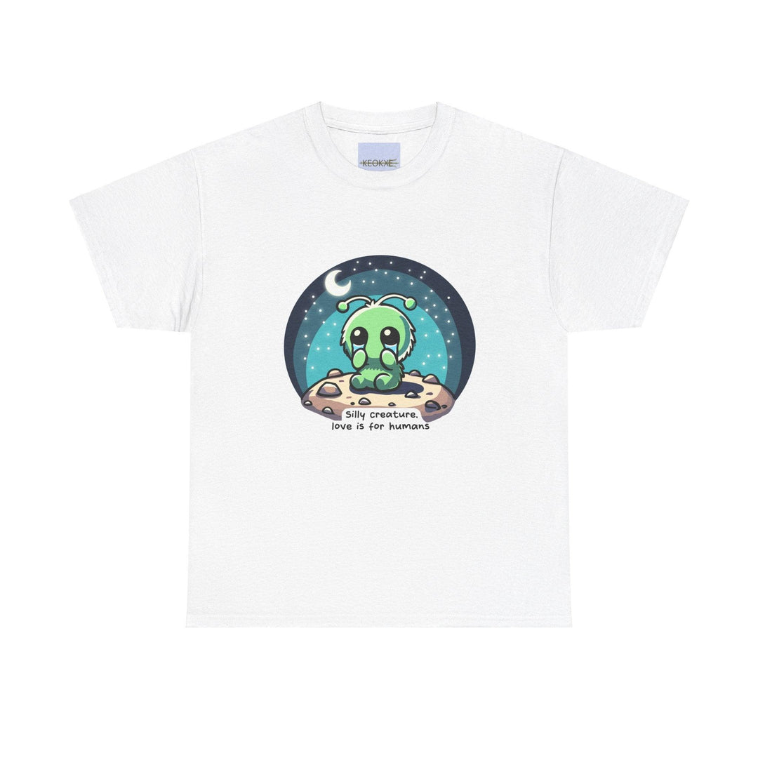 White unisex T-shirt featuring an alien creature under a starry sky with the phrase 'Silly Creature, Love Is for Humans.' A whimsical and slightly cynical design for sci-fi lovers with a unique sense of humor.