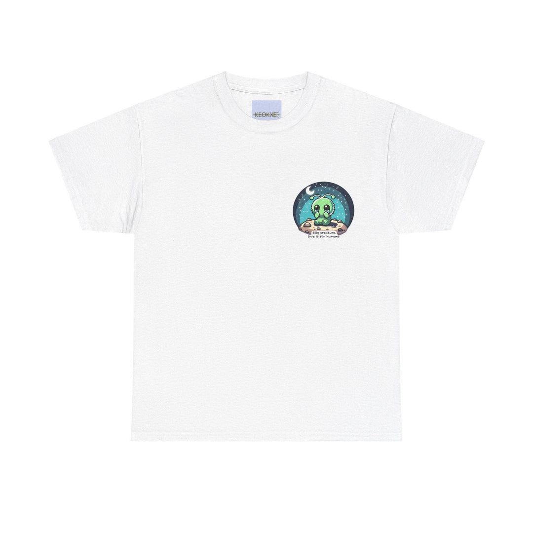 White unisex T-shirt featuring an alien creature under a starry sky with the phrase 'Silly Creature, Love Is for Humans.' A whimsical and slightly cynical design for sci-fi lovers with a unique sense of humor.