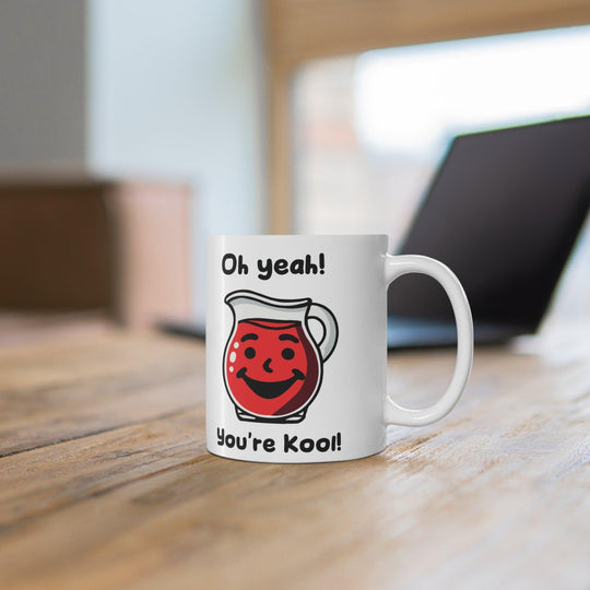 Fun white ceramic mug featuring a red Kool-Aid pitcher and the playful phrase 'Oh Yeah! You're Kool!' adding a retro vibe to your coffee routine
