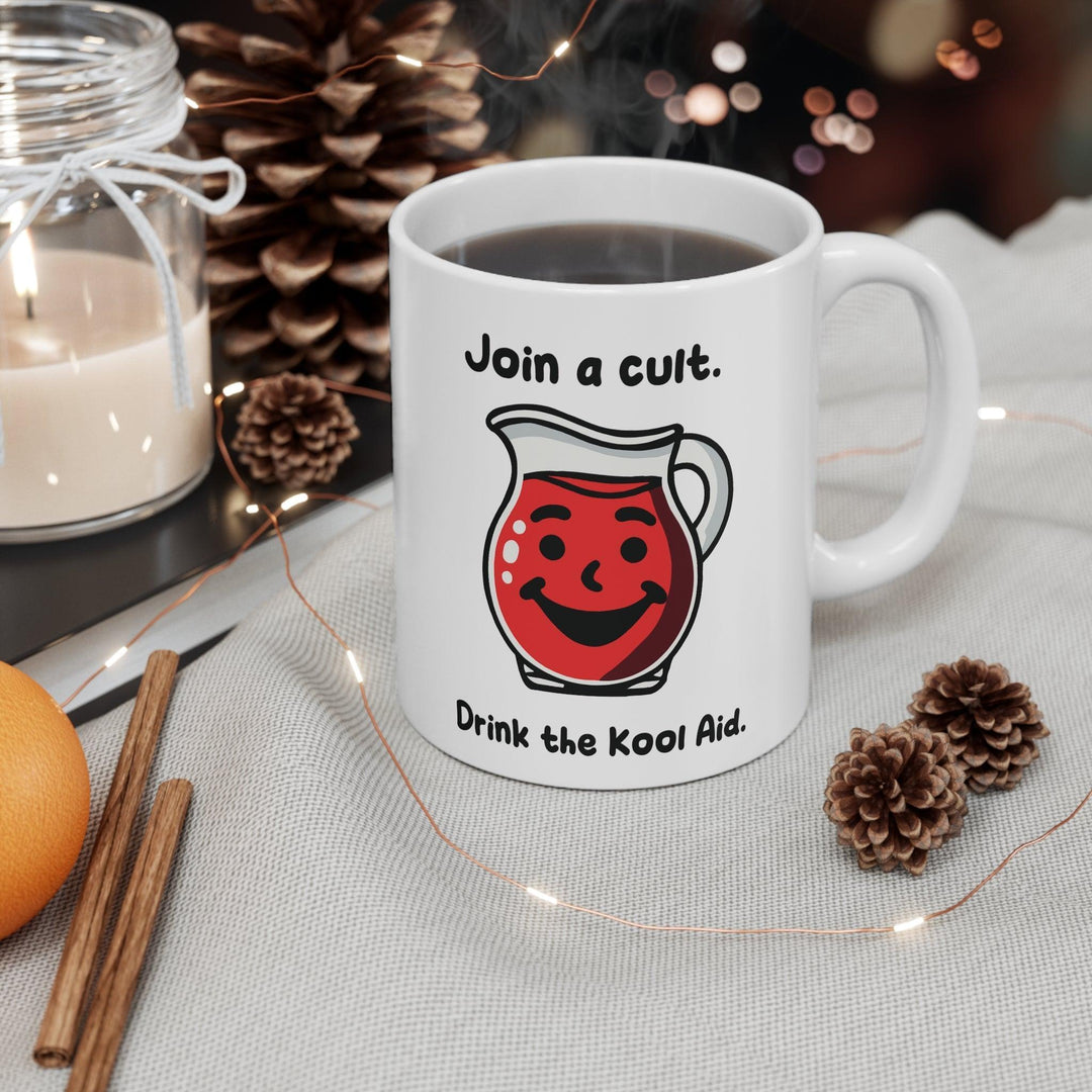 White ceramic mug featuring a red Kool-Aid pitcher illustration and the playful text 'Join a Cult, Drink the Kool-Aid,' adding a bold and humorous touch to your mug collection.
