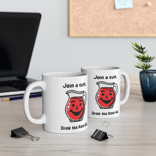 White ceramic mug featuring a red Kool-Aid pitcher illustration and the playful text 'Join a Cult, Drink the Kool-Aid,' adding a bold and humorous touch to your mug collection.