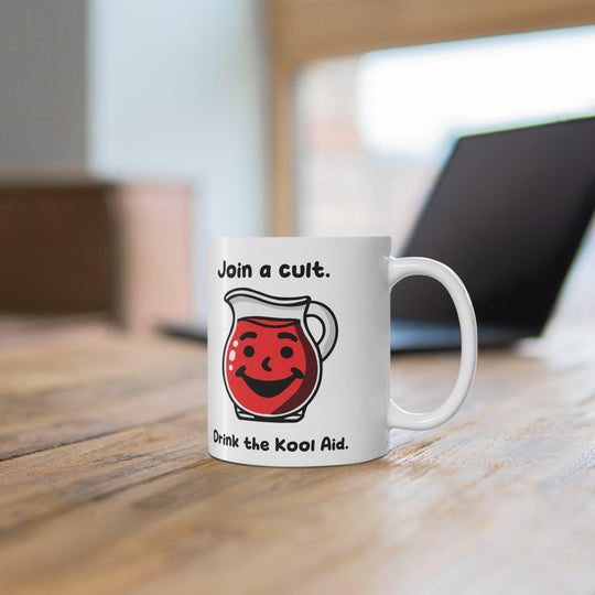 White ceramic mug featuring a red Kool-Aid pitcher illustration and the playful text 'Join a Cult, Drink the Kool-Aid,' adding a bold and humorous touch to your mug collection.