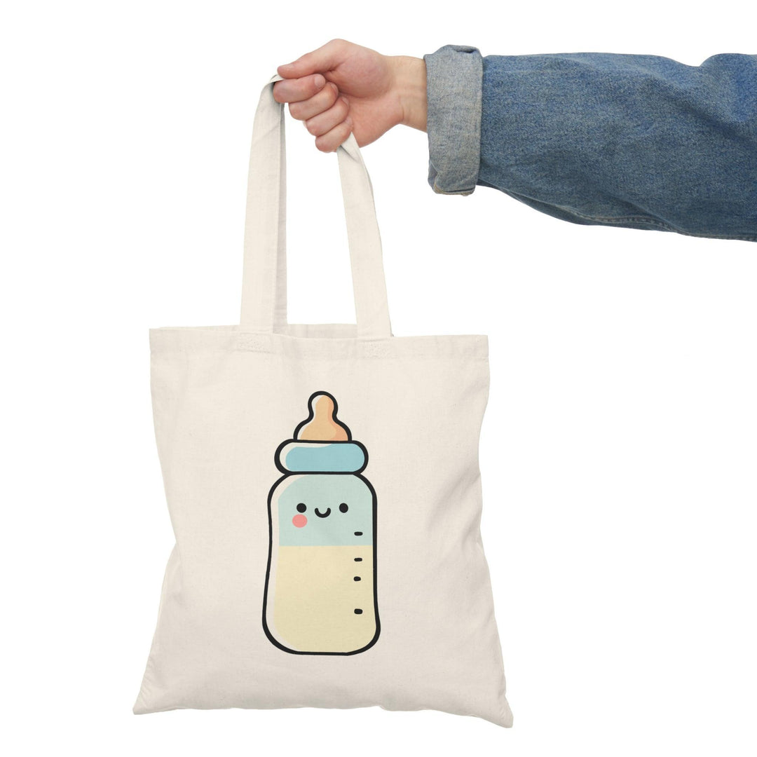 Tote bag featuring a charming illustration of a cute cartoon bottle, adorned with a happy face and playful colors. The whimsical design adds a fun and cheerful touch, making it a perfect accessory for anyone looking to brighten up their everyday style while showcasing their love for fun beverages.