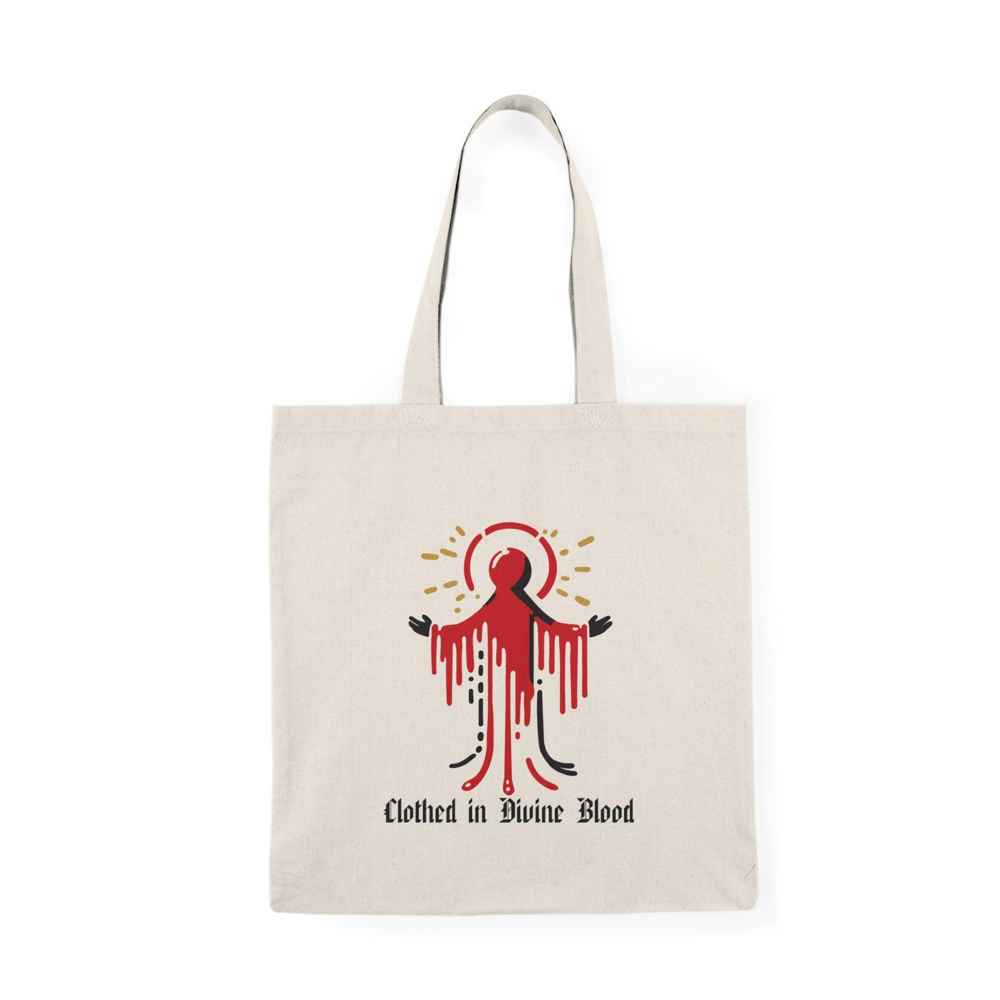 Tote bag featuring a striking design with the phrase 'Clothed in Divine Blood' artistically displayed alongside vivid graphics. The powerful imagery and bold colors convey a message of faith and strength, making it a unique accessory for those who want to express their spirituality with style."

