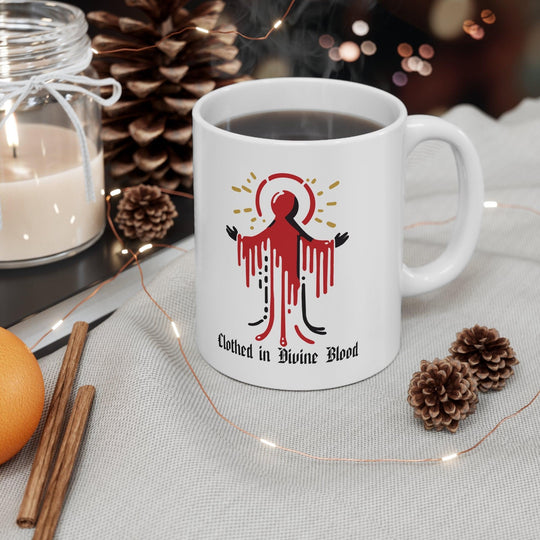Bold white ceramic mug featuring a dramatic dripping red design with the text 'Clothed in Divine Blood,' perfect for a striking and gothic aesthetic