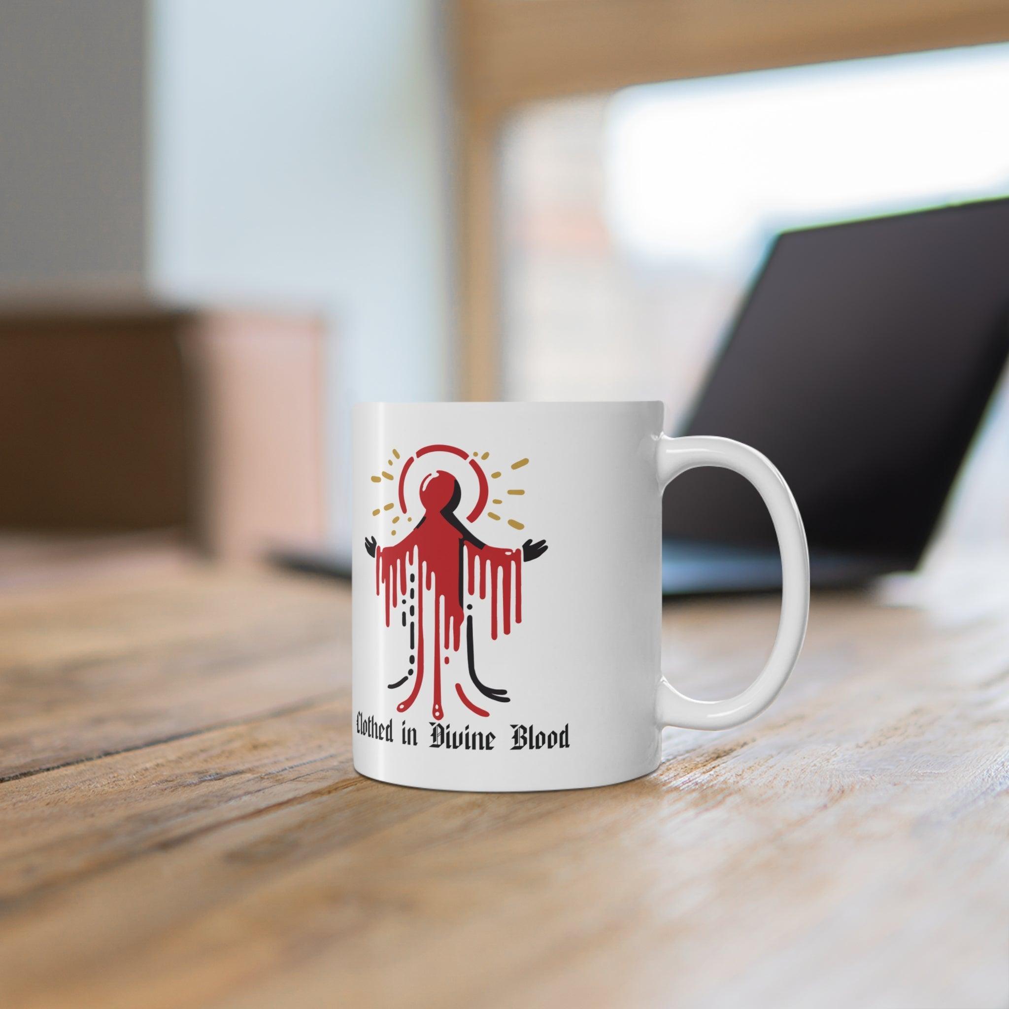 Bold white ceramic mug featuring a dramatic dripping red design with the text 'Clothed in Divine Blood,' perfect for a striking and gothic aesthetic