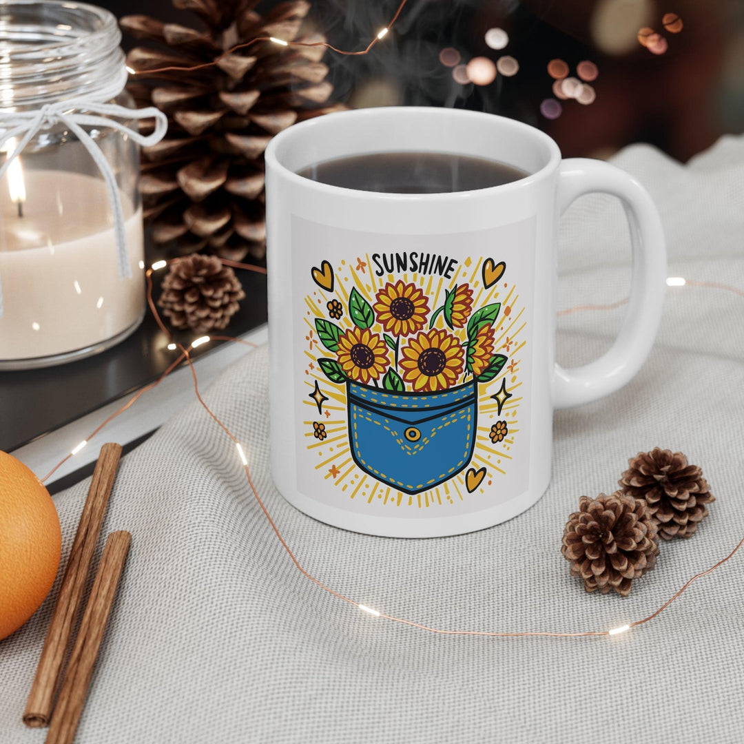 White ceramic mug featuring a sunflower design and the uplifting phrase 'Pocket Full of Sunshine,' bringing a bright and cheerful vibe to your mornings.