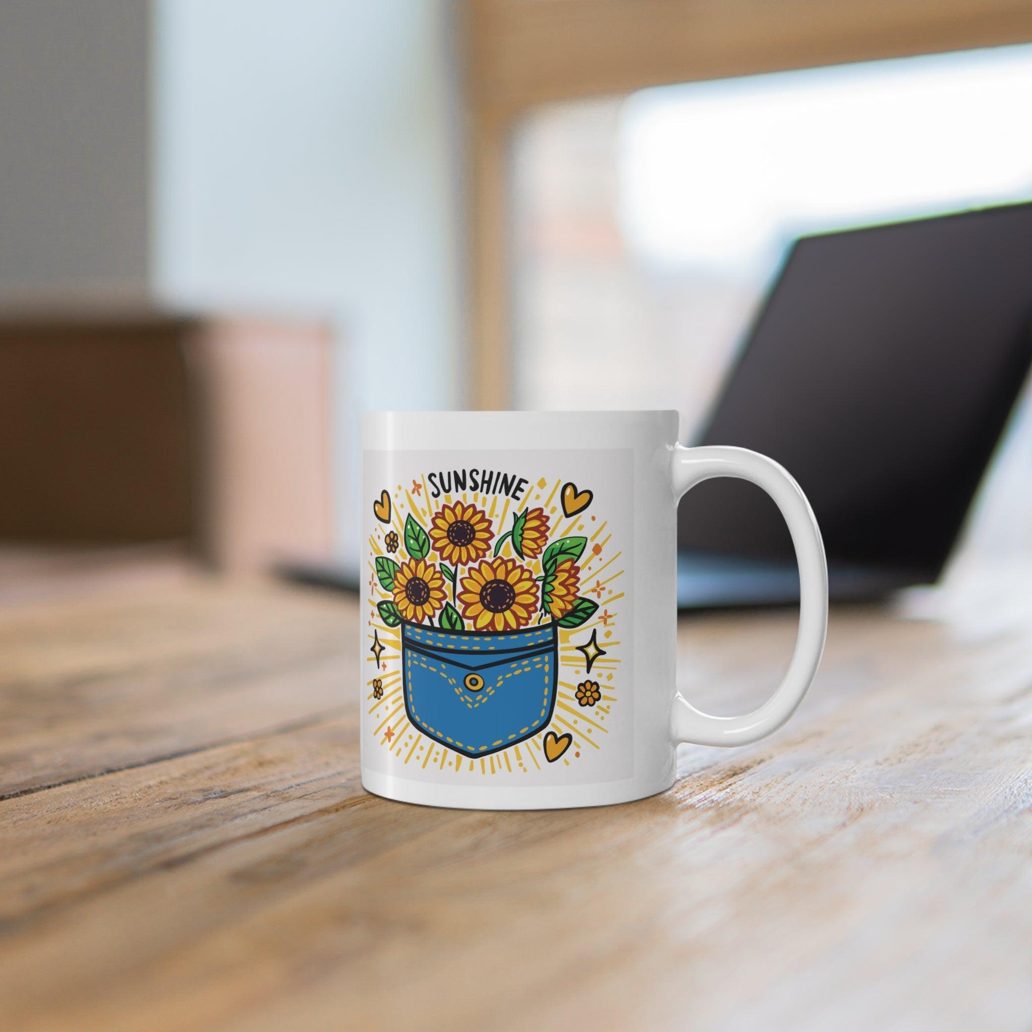 White ceramic mug featuring a sunflower design and the uplifting phrase 'Pocket Full of Sunshine,' bringing a bright and cheerful vibe to your mornings.