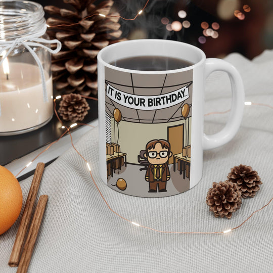 White ceramic mug featuring a reference to the iconic 'It Is Your Birthday' scene from The Office, ideal for fans of the show who enjoy a subtle nod to their favorite series
