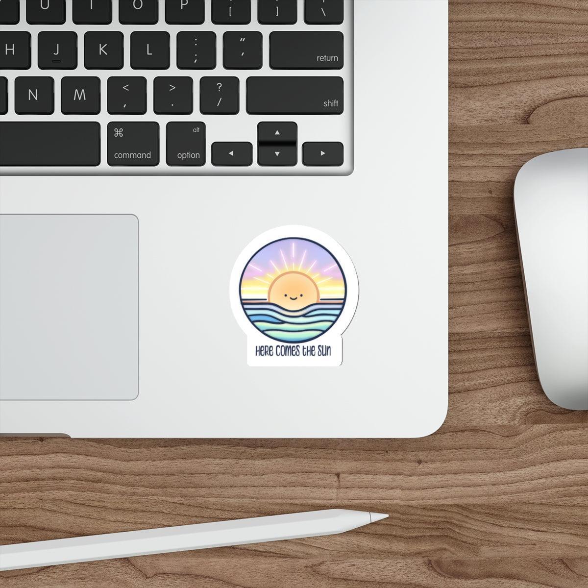 Colorful and uplifting waterproof sticker featuring a rising sun with the words 'Here Comes The Sun.' A bright and cheerful addition to laptops, water bottles, or notebooks - Baby Keo