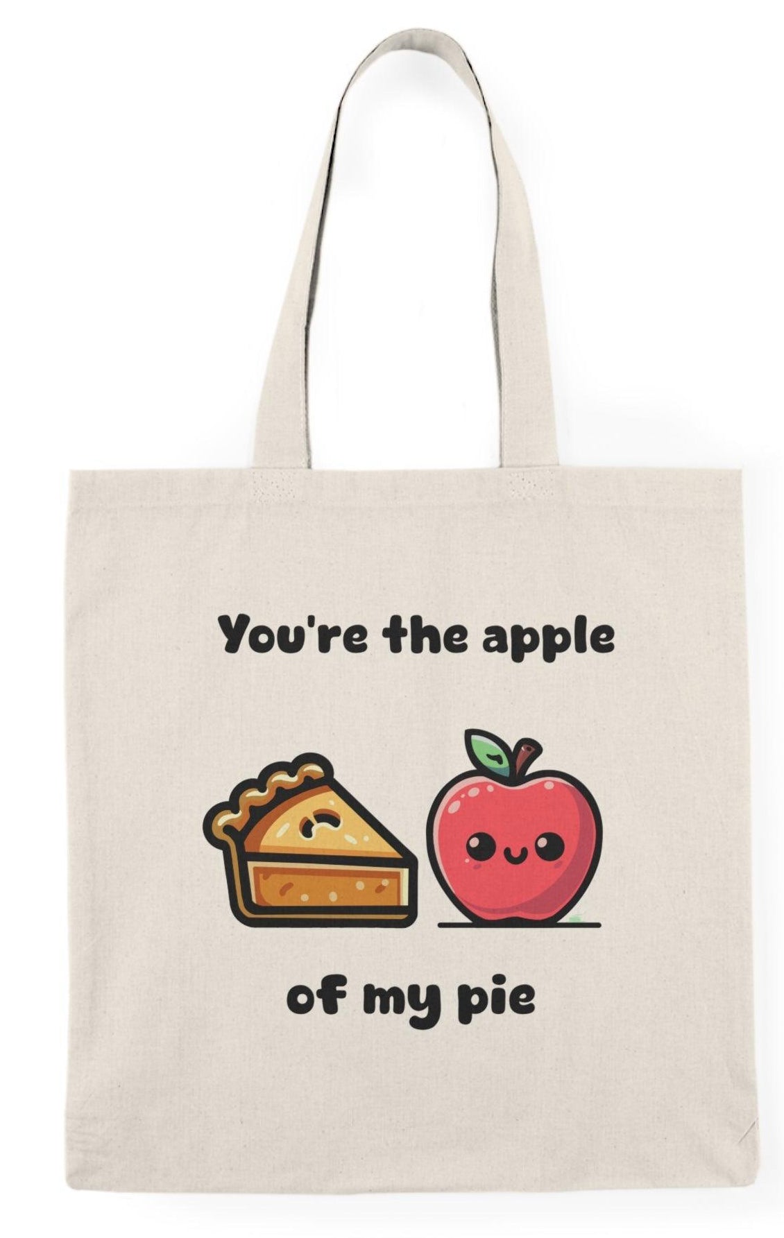 A cream tote bag featuring a delightful graphic of an apple pie with apples on either side and the text 'You're the apple of my pie.' This punny design adds a touch of sweetness and charm, making it an ideal gift for food lovers and those with a sweet tooth.