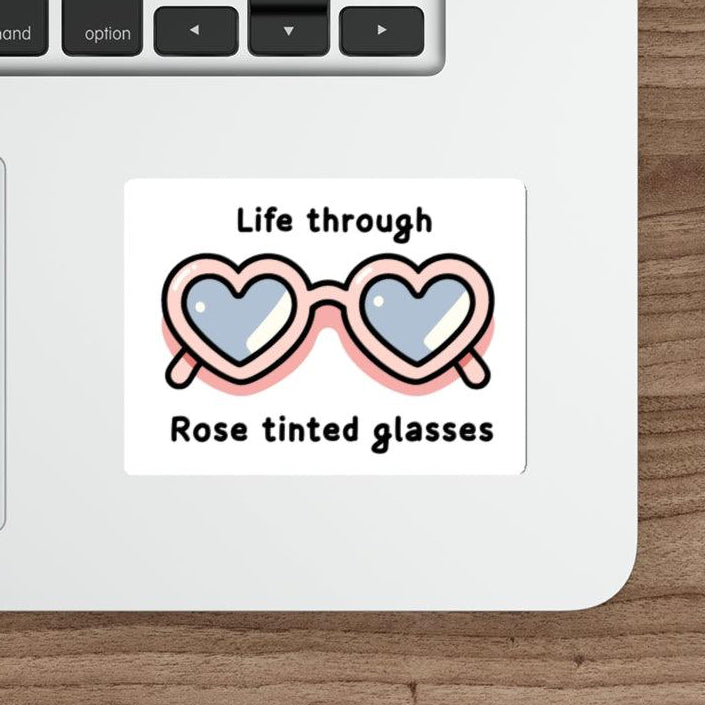  A cute pair of glasses with hearts in the lenses and the text "Life through Rose tinted glasses." A whimsical design.  KEOLIX 