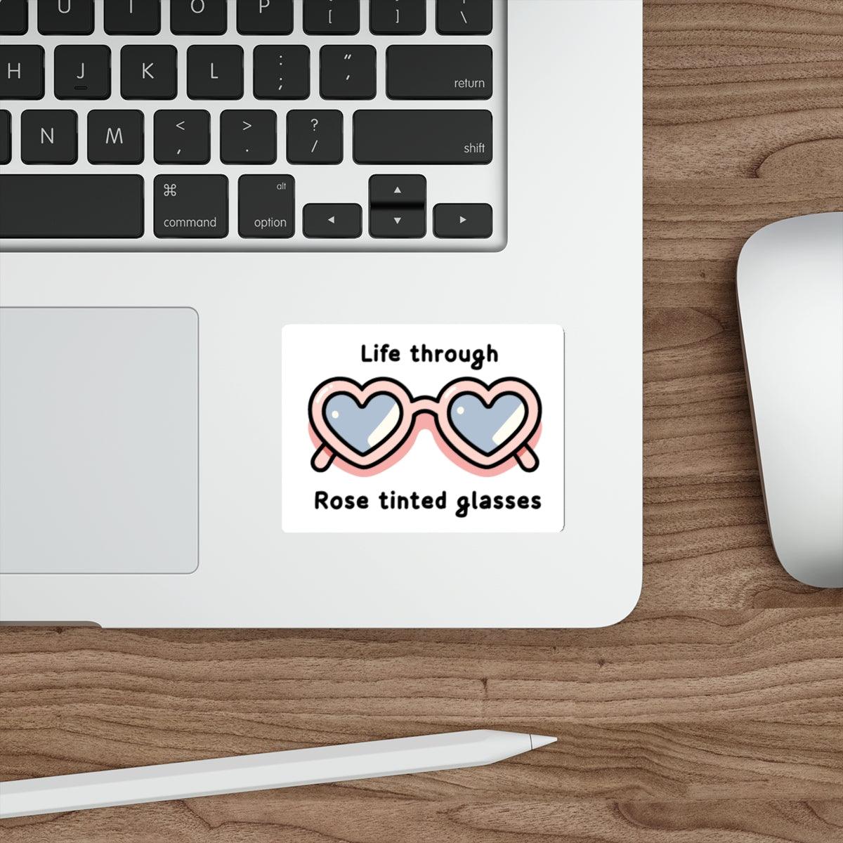  A cute pair of glasses with hearts in the lenses and the text "Life through Rose tinted glasses." A whimsical design.  KEOLIX 
