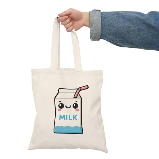 Tote bag featuring an adorable illustration of a cartoon milk carton with a smiling face and playful graphics. The cheerful design and bright colors make it a delightful accessory, perfect for milk lovers and anyone looking to add a fun touch to their everyday style