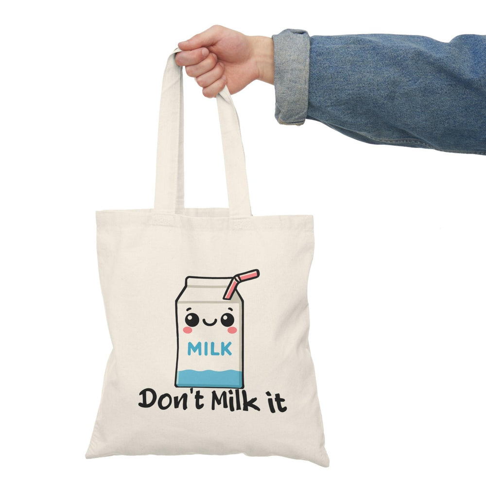 Tote bag featuring a playful illustration of a cartoon milk carton with the phrase 'Don't Milk It.' The vibrant design and cheerful graphics create a fun and whimsical accessory, perfect for adding a lighthearted touch to your everyday style while showcasing a love for dairy."