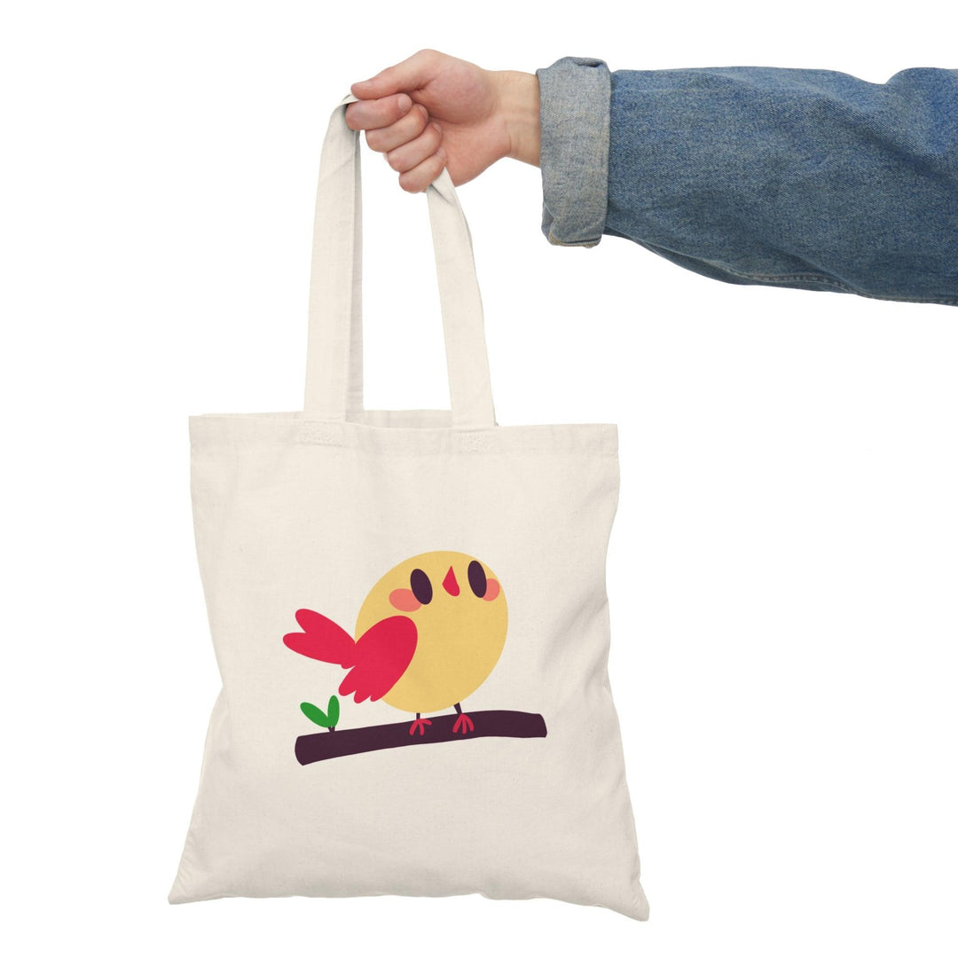 Tote bag featuring a charming illustration of a cartoon bird perched on a branch, surrounded by whimsical foliage. The vibrant colors and playful design create a cheerful and uplifting accessory, perfect for bird lovers and anyone looking to add a touch of nature-inspired fun to their everyday style.