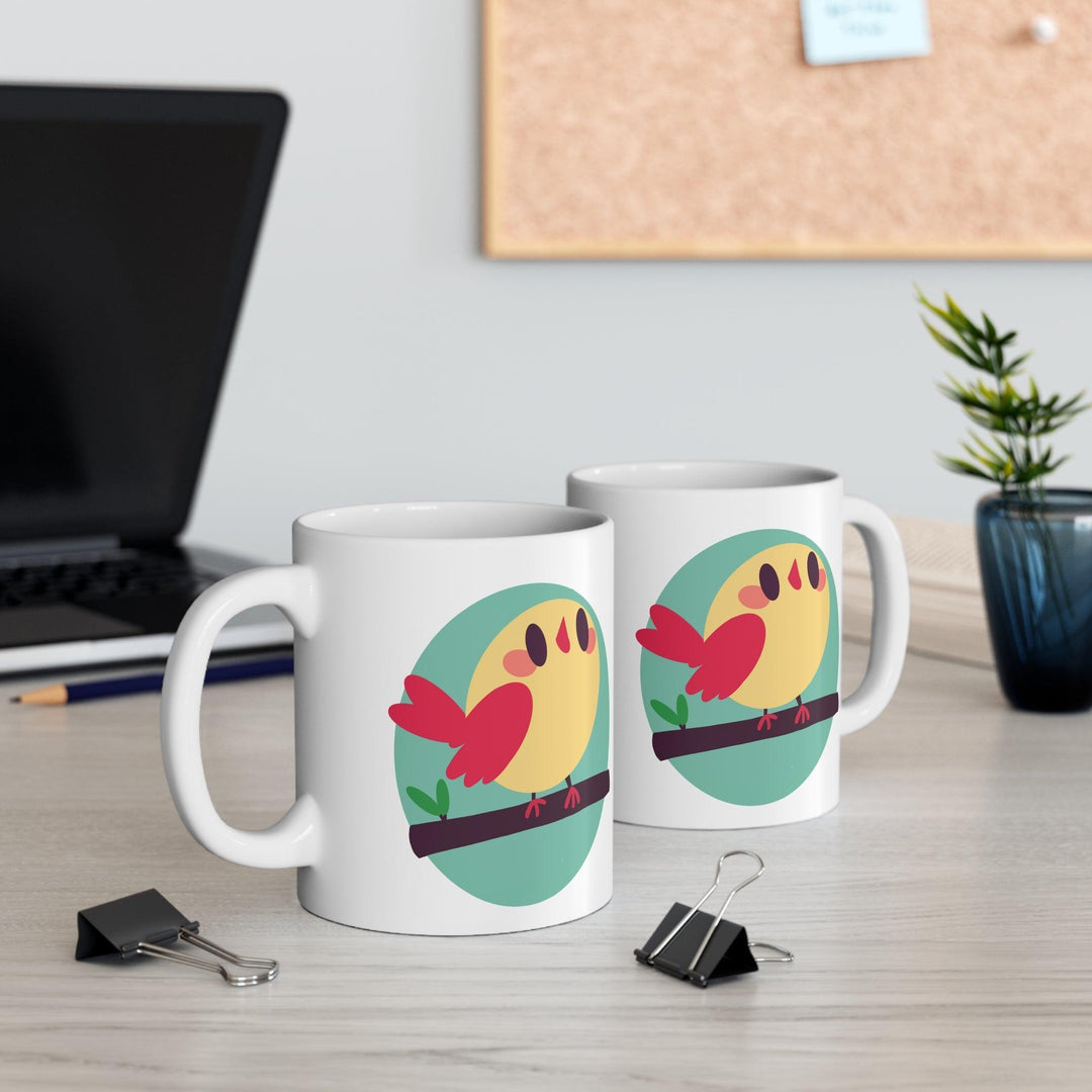 Vibrant white ceramic mug showcasing a cheerful cartoon bird perched on a branch, adding a touch of nature and whimsy to your morning routine