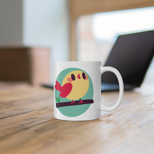 Vibrant white ceramic mug showcasing a cheerful cartoon bird perched on a branch, adding a touch of nature and whimsy to your morning routine