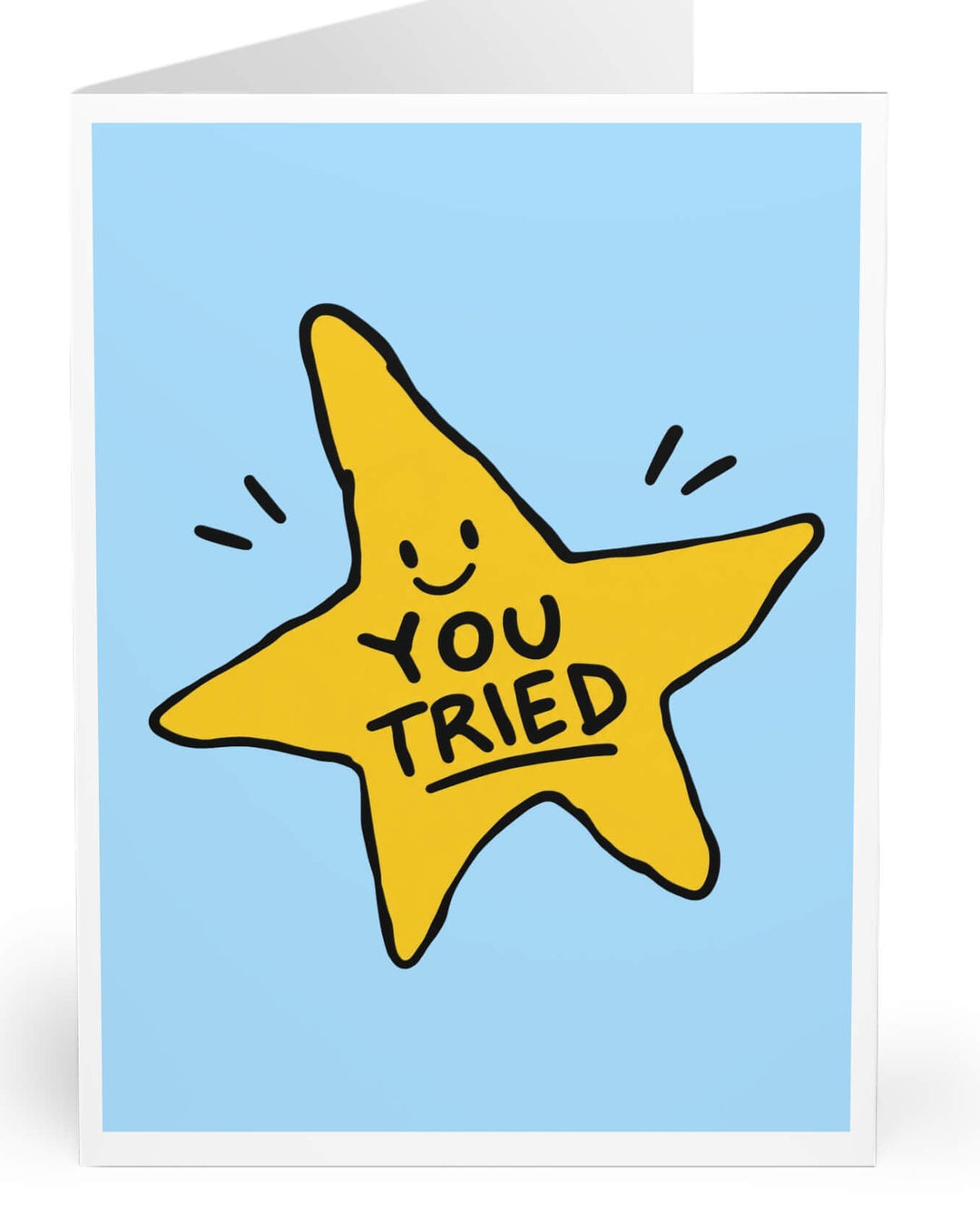 A folded greeting card shown upright on a white background. The front has a light blue panel with a large yellow star illustration and the words 'YOU TRIED' in black.