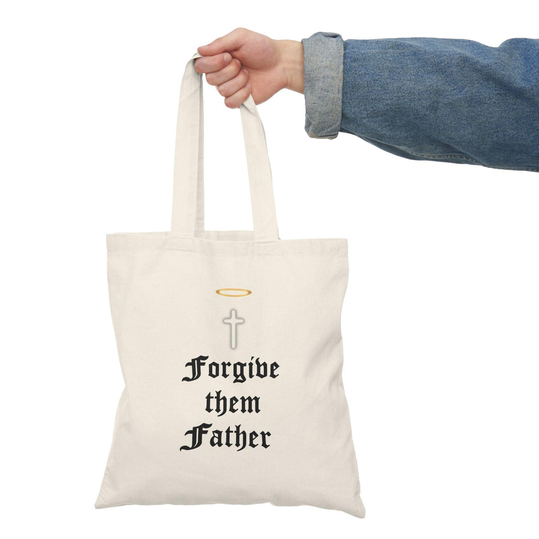 Tote bag made from 100% recycled cotton, featuring a poignant design of a cross with a halo and the phrase 'Forgive Them Father.' Measuring 40 x 38cm, this lightweight yet durable bag is perfect for carrying daily essentials while making a powerful statement about forgiveness and sustainability.