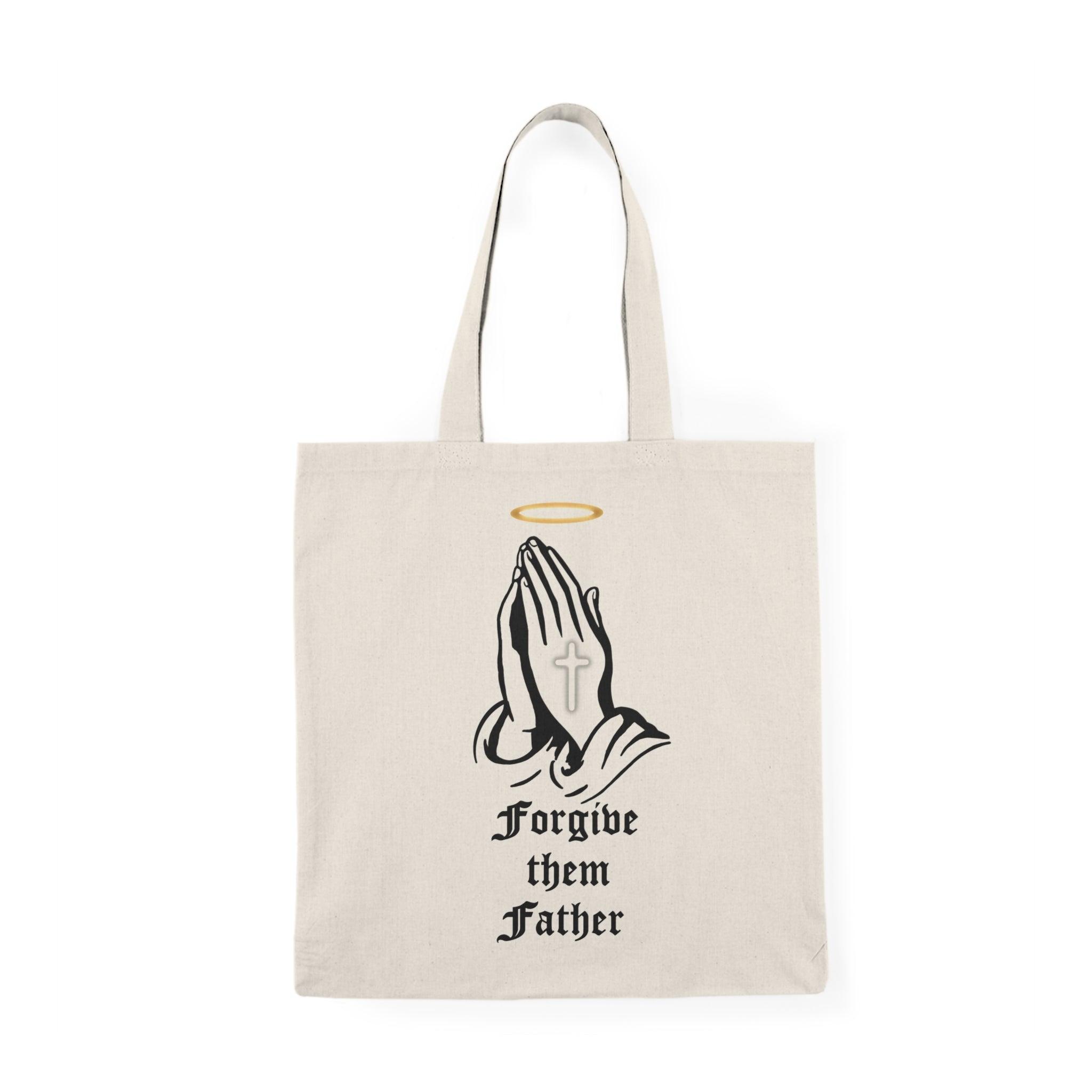 Tote bag made from 100% recycled cotton, featuring a striking design of a cross with a halo, accompanied by the impactful phrase 'Forgive Them Father.' Measuring 40 x 38cm (15.7 x 15 inches) and weighing 130-135 gsm, this lightweight yet sturdy bag is perfect for daily essentials, making a meaningful statement about forgiveness and eco-conscious living."