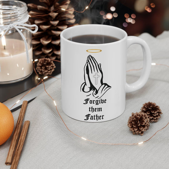 Classic white ceramic mug featuring praying hands and the text 'Forgive Them Father,' ideal for those who appreciate faith-inspired designs