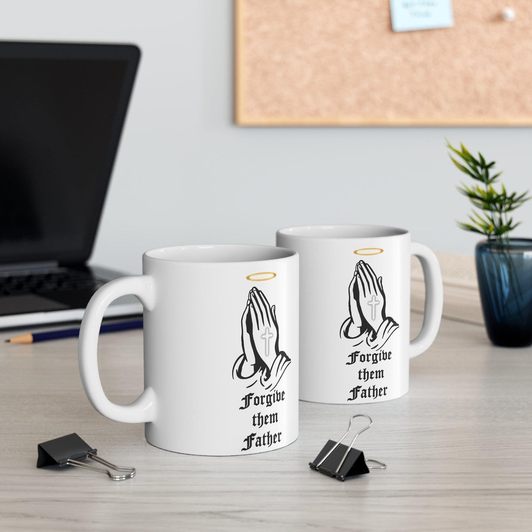 Classic white ceramic mug featuring praying hands and the text 'Forgive Them Father,' ideal for those who appreciate faith-inspired designs