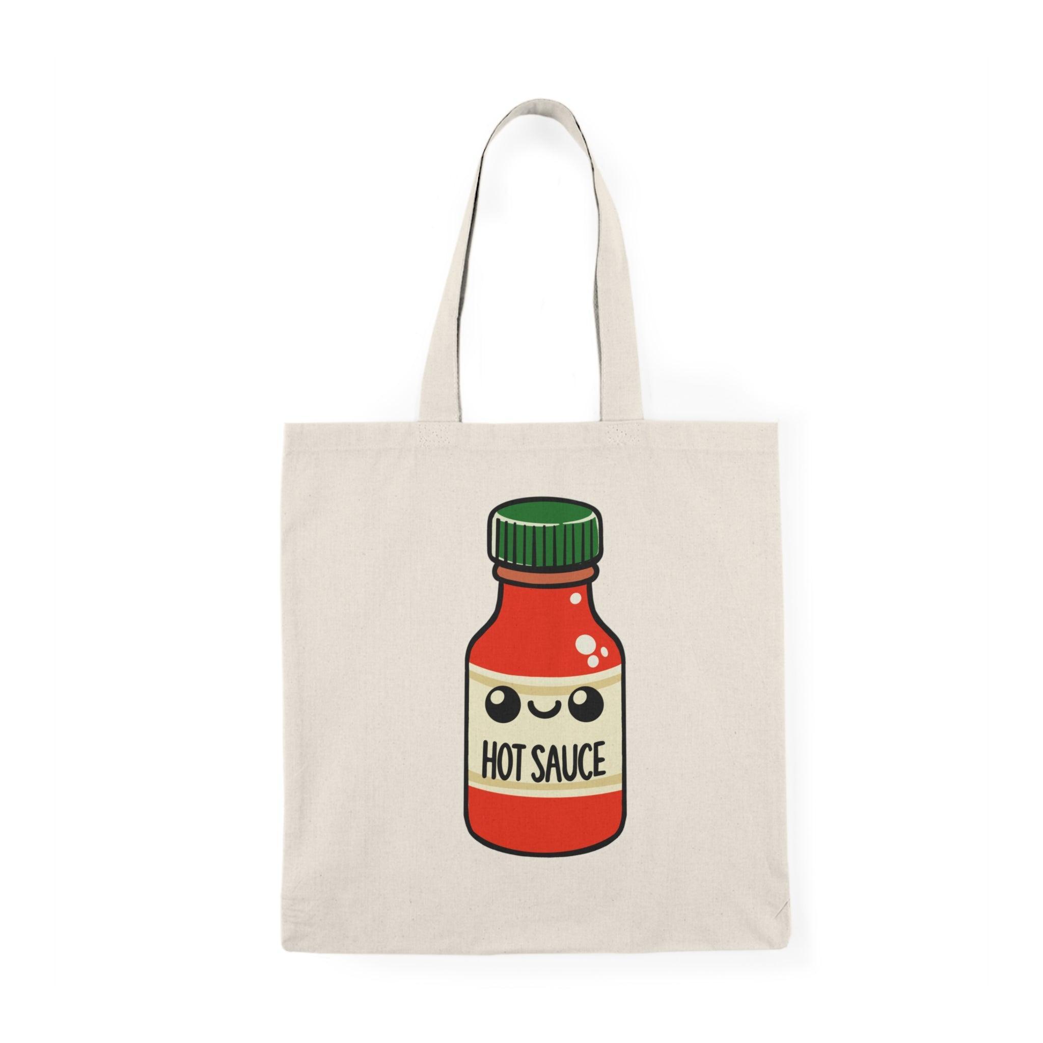 Tote bag featuring a fun and vibrant illustration of a cartoon hot sauce bottle, complete with playful graphics and bright colors. The lively design adds a spicy flair to your everyday carry, making it a perfect accessory for hot sauce enthusiasts and anyone who loves bold flavors