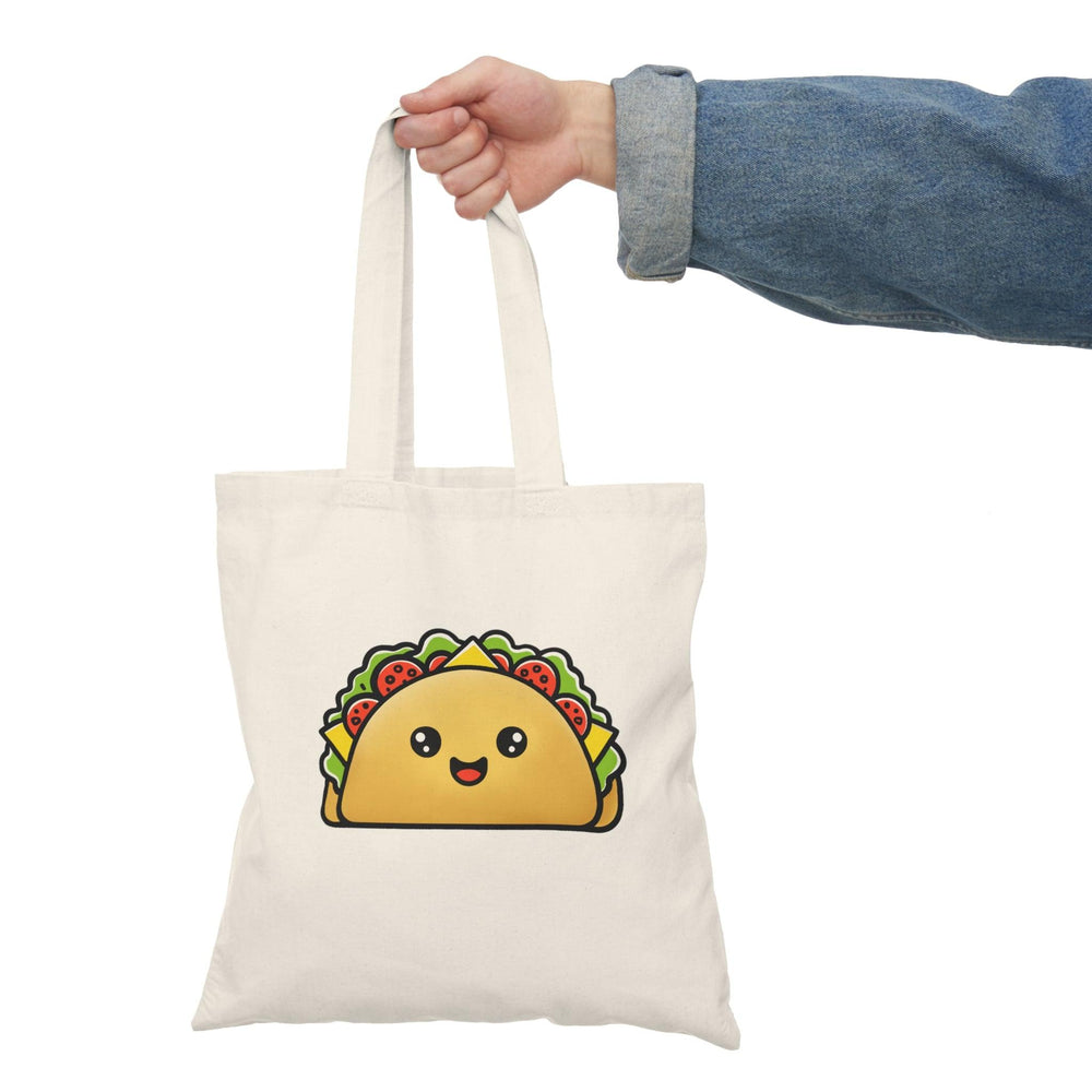 Tote bag featuring a playful illustration of a cartoon taco, overflowing with colorful ingredients like lettuce, cheese, and salsa. The vibrant design and fun graphics make it a delightful accessory for taco lovers and a cheerful addition to any casual outfit."