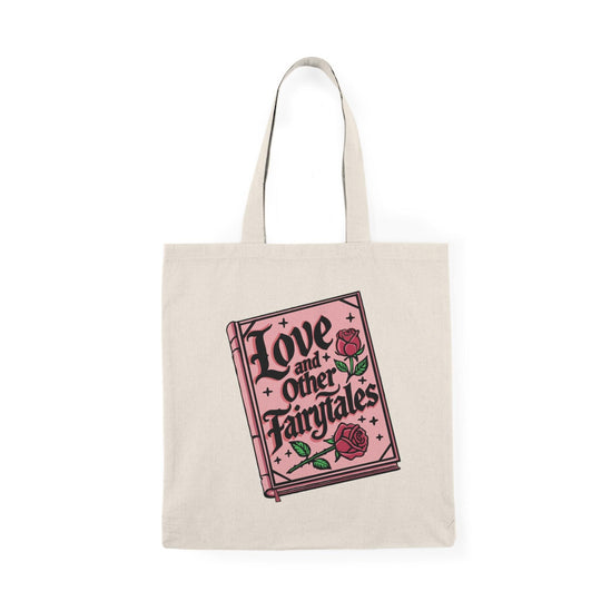 A natural canvas tote bag featuring a whimsical illustration with the text 'Love and Other Fairytales' surrounded by decorative elements. The enchanting design evokes a sense of magic and romance, making it an ideal accessory for dreamers and romantics