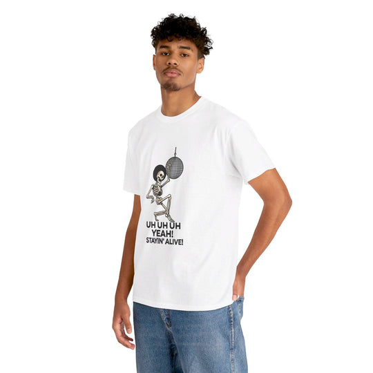 White T-shirt featuring a cartoon skeleton dancing to disco, with the phrase 'Uh Uh Uh Yeah! Stayin' Alive.' A fun and playful design for lovers of classic music and humorous artwork