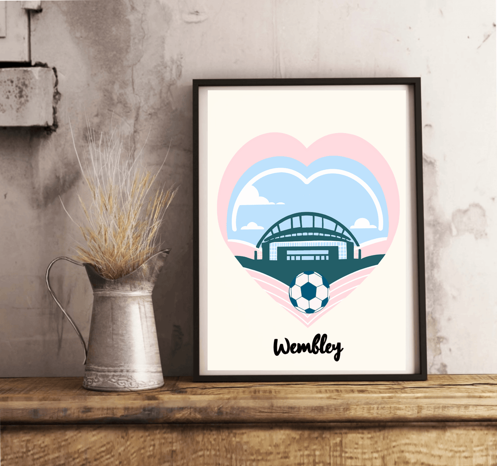 Add a touch of charm to your space with "The Wembley Essence" - an eye-catching Minimalist Football Print that's sure to capture hearts! This beautifully designed print rests gracefully on a wooden floor against a crisp white wall. It features the iconic Wembley Stadium nestled inside a vibrant blue heart outlined in playful pink, complete with a soccer ball poised perfectly at the tip. The word "Wembley" stands proudly beneath, perfectly encapsulating its spirit. Let this timeless piece bring elegance and 