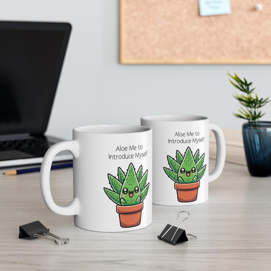 White ceramic mug showcasing a cute aloe plant in a pot with the pun 'Aloe Me to Introduce Myself,' surrounded by a warm, cozy ambiance