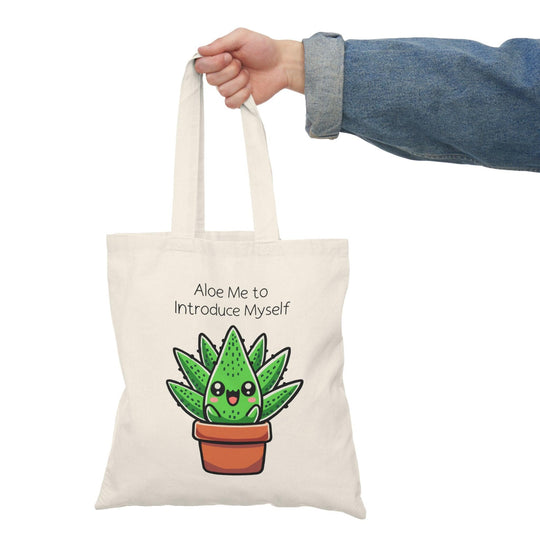 Art print featuring a charming illustration of a cute aloe plant with a friendly face, accompanied by the playful phrase 'Aloe Me to Introduce Myself.' The design combines vibrant greens and whimsical elements, creating a delightful and inviting piece that adds a touch of personality to any space.