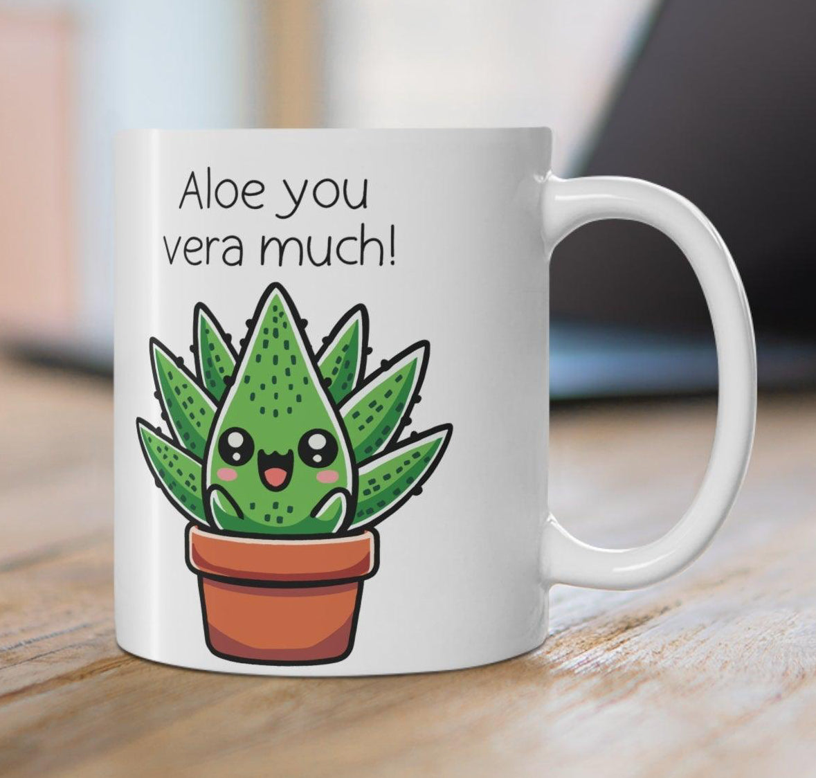 un white ceramic mug featuring an adorable aloe plant illustration with the witty phrase 'Aloe You Vera Much,' styled with a wintery, cozy setup