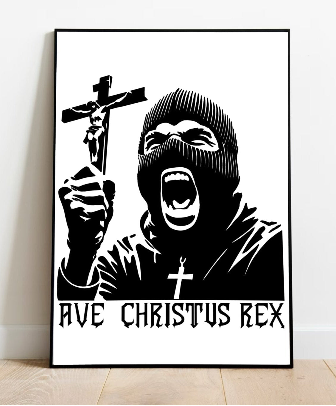 Introducing the "Ave Christus Rex Print"—a mesmerizing black and white masterpiece that captures an individual in a balaclava passionately holding up a crucifix. The striking phrase "AVE CHRISTUS REX" boldly adorns the bottom, adding to its commanding presence. This exquisite piece of religious art comes beautifully framed, ready to grace your space as it rests elegantly on a wooden floor against a clean white wall. Perfect for creating an inspiring focal point in any room!